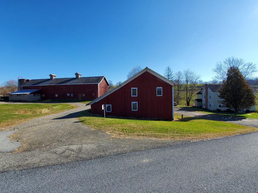Great Land with over a half mile of road frontage and story book setting red barn