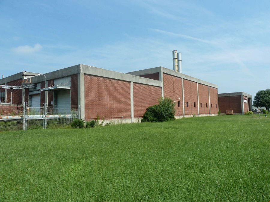Former Talon Zipper Manufacturing/Warehouse - 105,251 SF - Adjacent to Runway with Potential IOS Land - 20 +/- Acres - Opportunity Zone